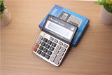 Calculator on a wooden surface with a book in the background
