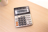 Calculator on a wooden surface with a blurred background